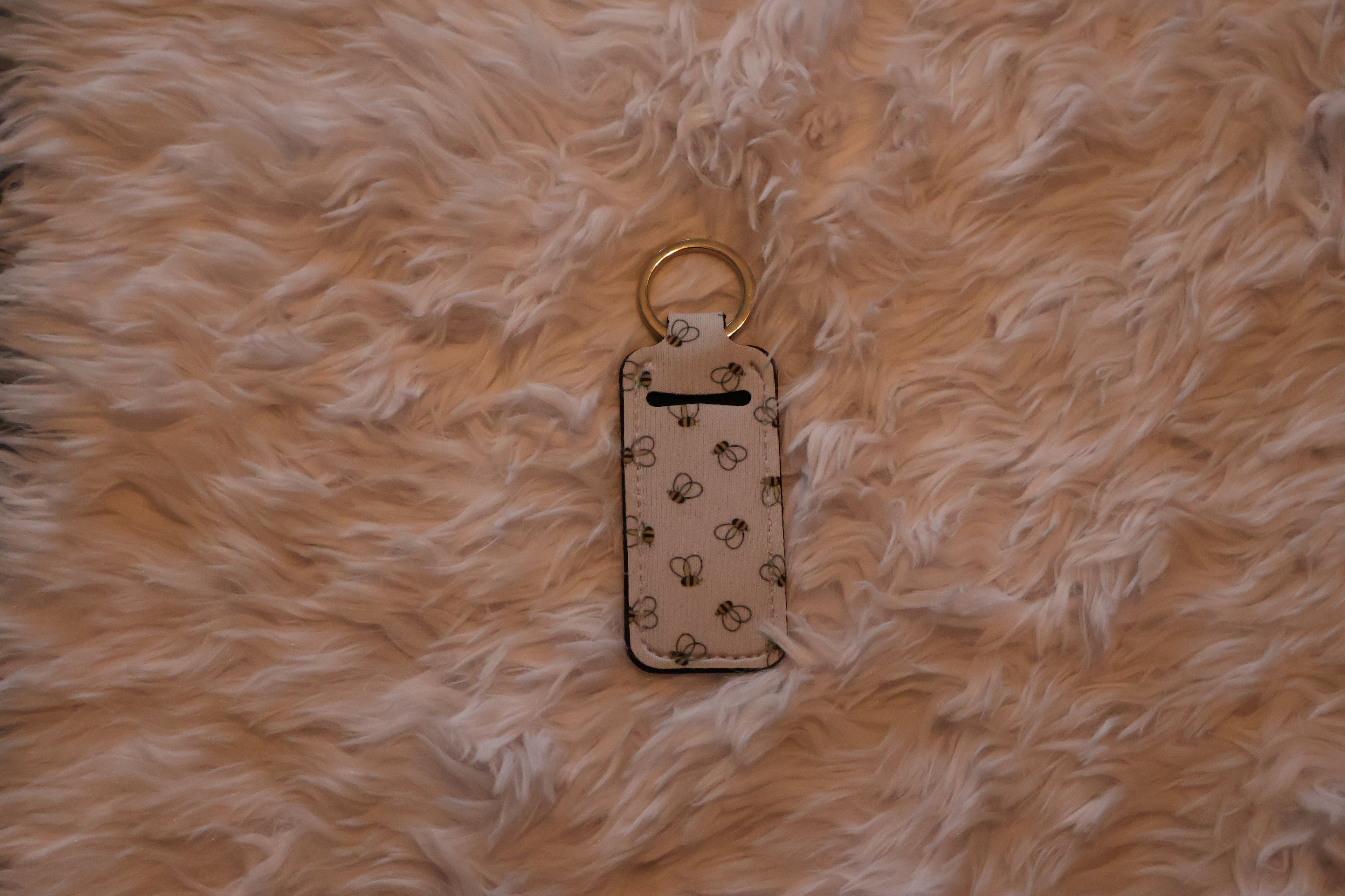 Chapstick holder with bee print pattern.